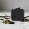 Raw Natural Black Soap Bar - artisanal charcoal soap on white marble