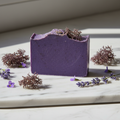 Purple Sea Moss Soap bar on white marble with sea moss and wildflowers